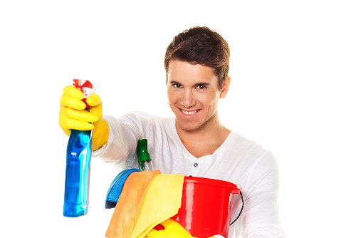Cleaner working on upper-floor windows of a South London property in SW2